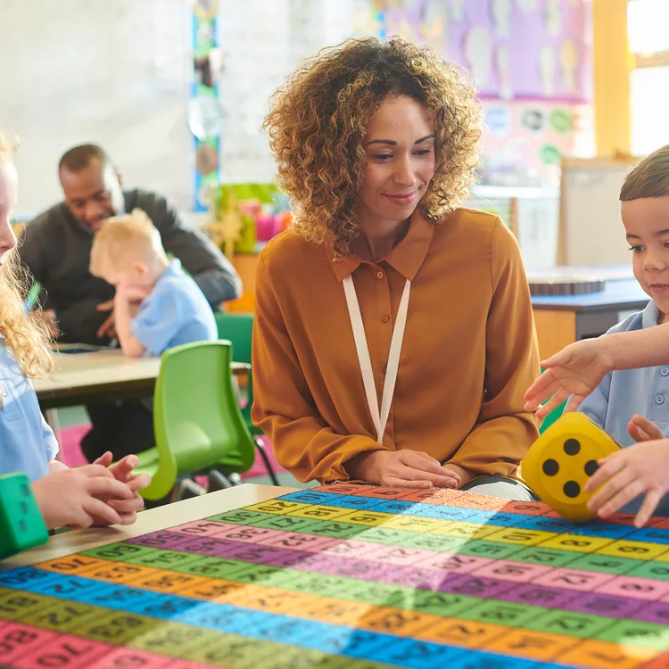 Early years leader working alongside children